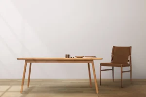 Scandinavian serenity style dining table in natural wood finish with simple lines paired with a sleek tan leather chair