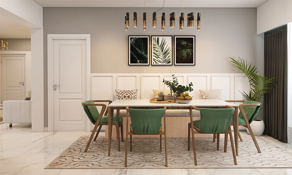 Chic dining room featuring a mid century modern table with green upholstered chairs and elegant decor