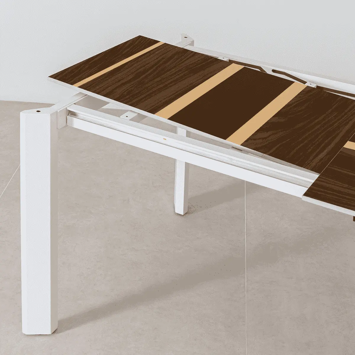 Detail of a modern extendable dining tables mid expansion showing the contrasting wood patterns and white support frame