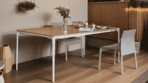 Long extendable outdoor dining table with a wooden finish showcasing a minimalist design in a bright space