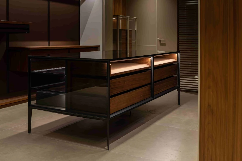 Elegant black sideboard cabinet featuring wood drawers and glass shelves