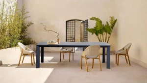 Elegant ceramic table set in a serene patio surrounded by lush plants and minimalist decor perfect for outdoor dining