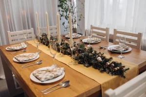 Elegantly set table with festive garland centerpiece perfect for holiday dining with a refined ambiance Ideal for family gatherings
