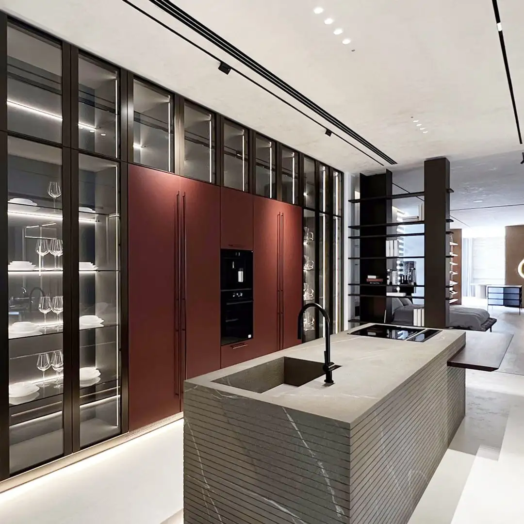 Sleek modern modular kitchen with glass cabinets and island sink