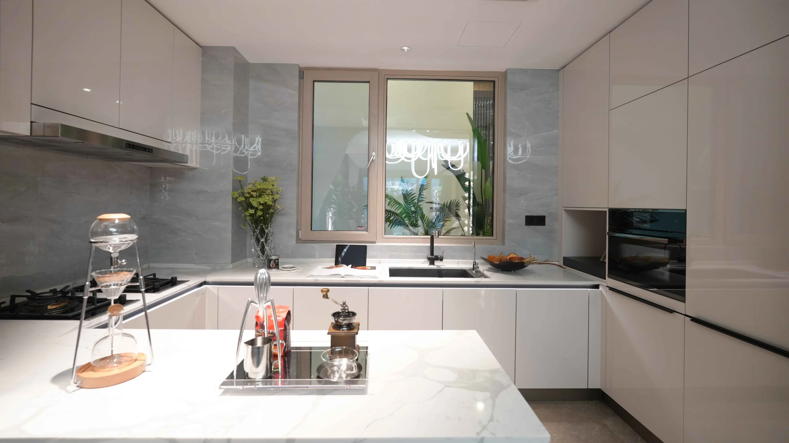 Bright kitchen with island sink and green plant decoration