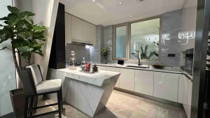 Full view of a sleek kitchen with an island and large window
