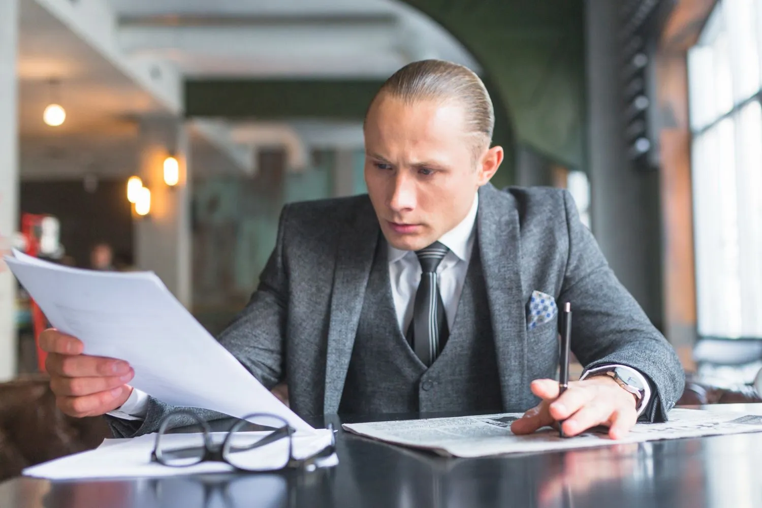 Man in a suit intently reading a quotation document