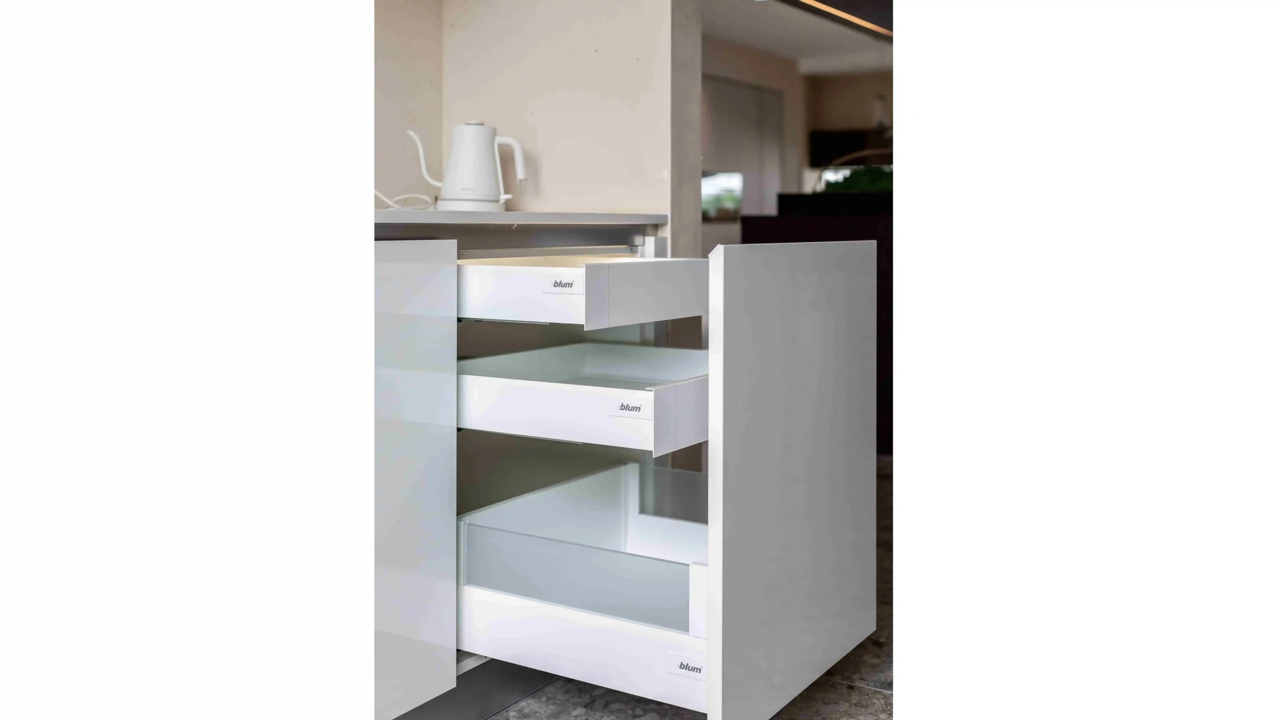 Pull out drawers with white dividers in a kitchen cabinet