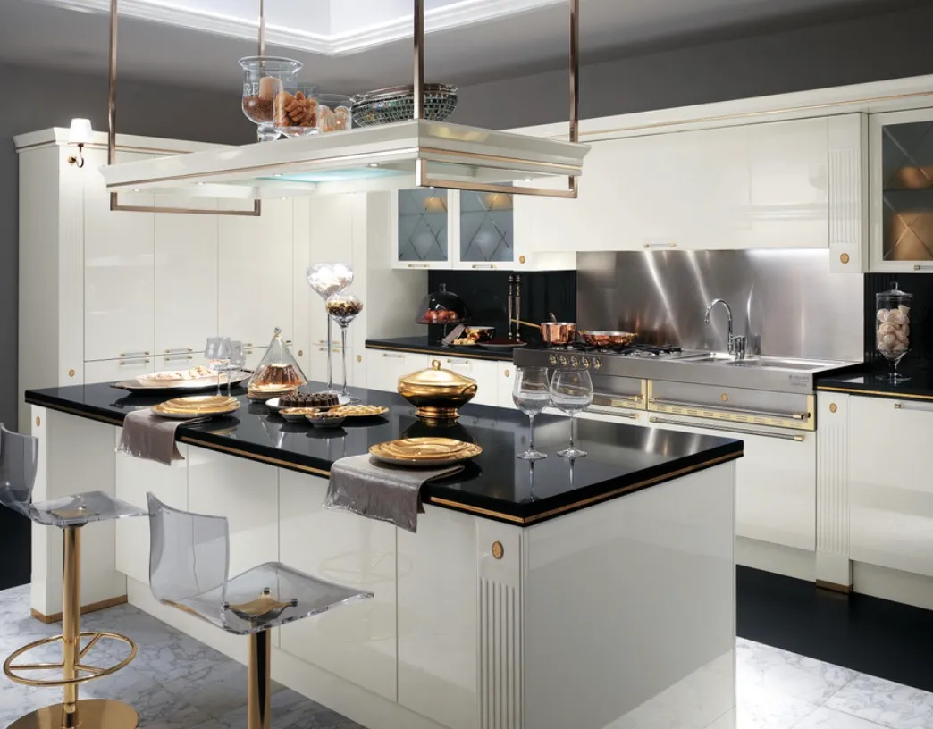 The kitchen cabinets are a glossy white with gold accents which add a touch of opulence to the space