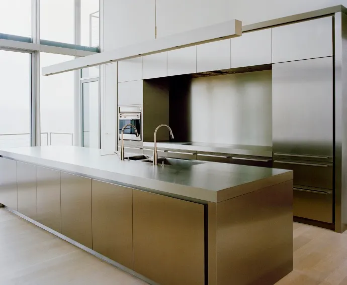The kitchen cabinets are made of stainless steel providing a contemporary and industrial look
