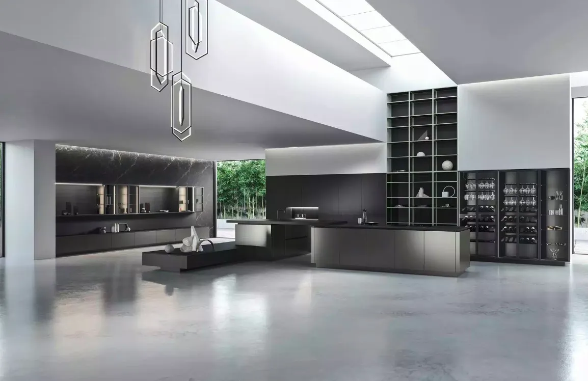 This image features a spacious modern kitchen with an open floor plan and high ceilings The design includes sleek dark cabinetry integrated appliances and a large island with clean lines