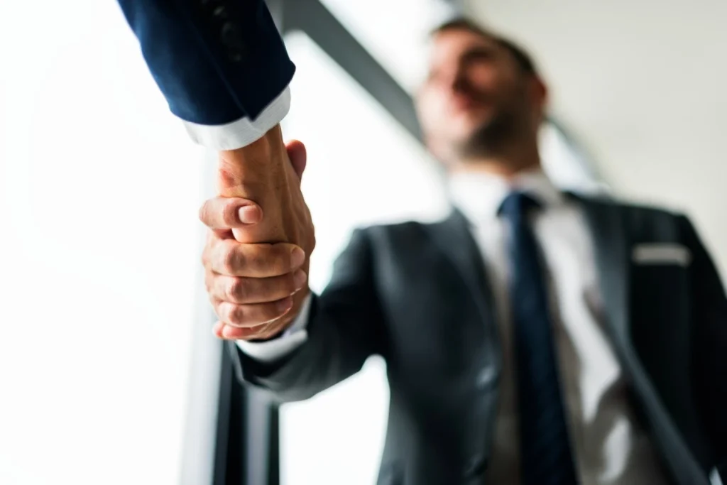 Two businessmen shaking hands in a formal agreement symbolizing a successful partnership