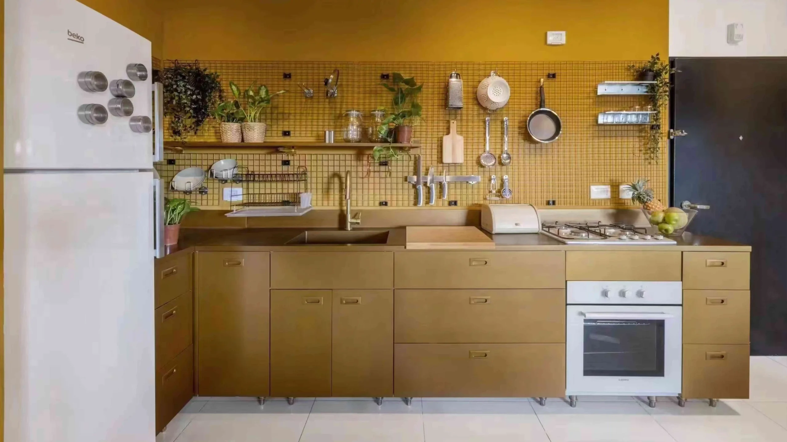 Yellow themed kitchen with open shelving and hanging plants