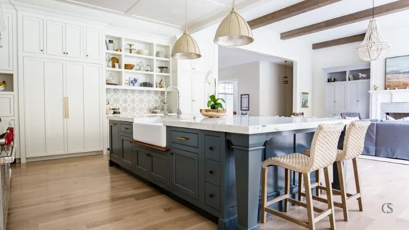 A modern kitchen featuring a large island with contrasting finishes A modern kitchen featuring a large island with contrasting finishes