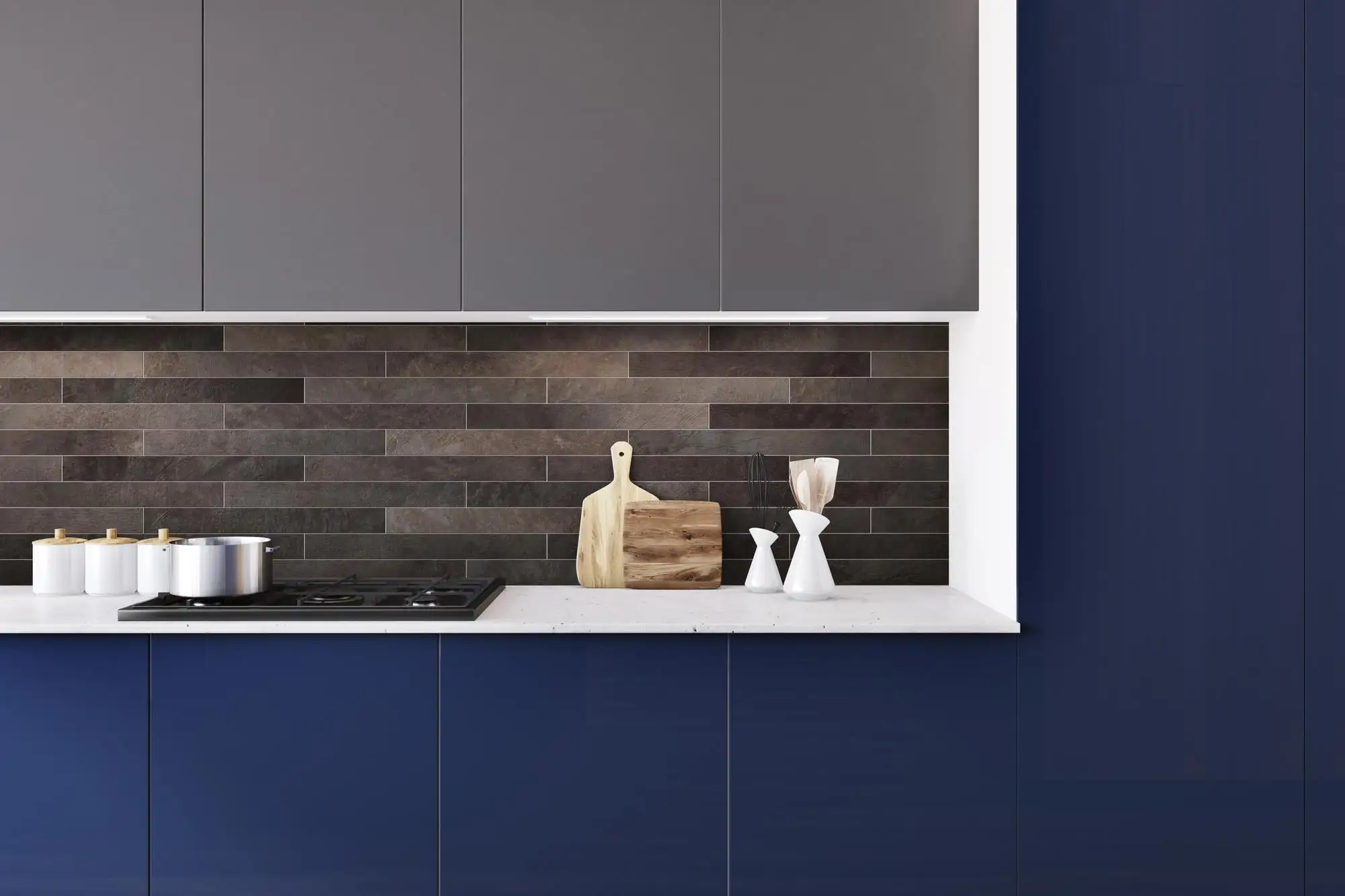 Blue kitchen cabinets with industrial style accents and a dark tile backsplash Blue kitchen cabinets with industrial style accents and a dark tile backsplash