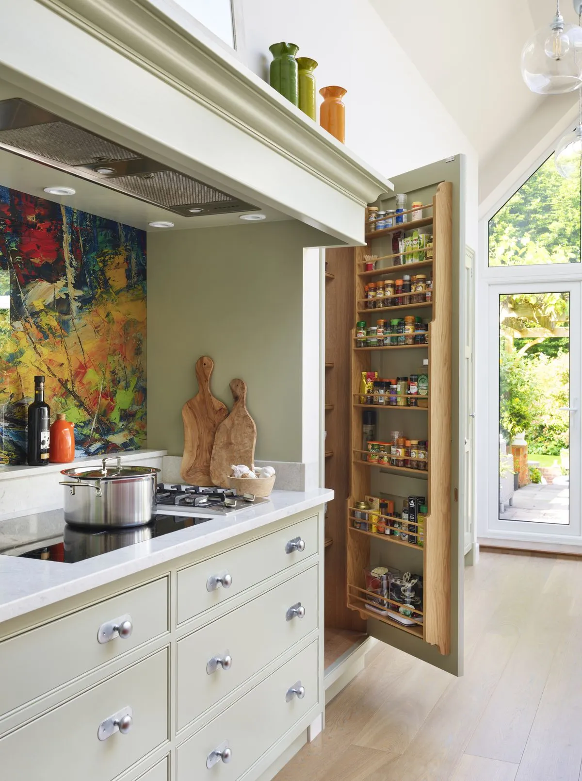 Built in spice racks in a compact organized kitchen