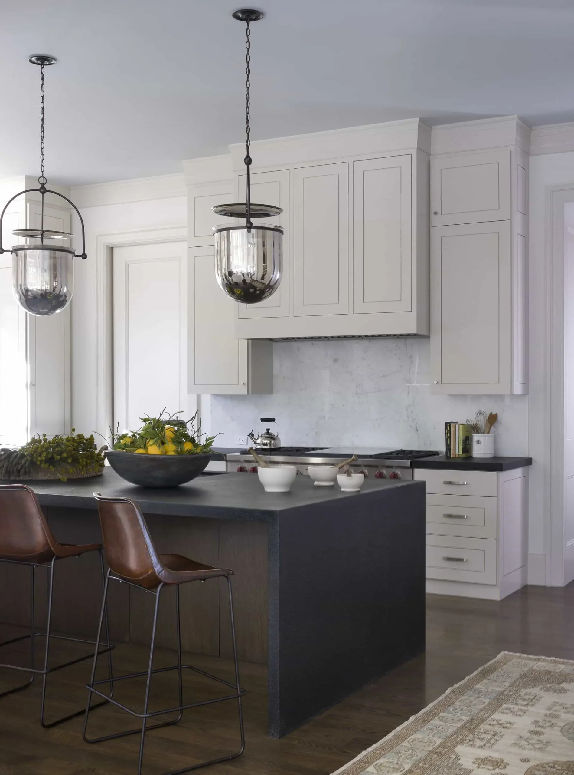 Contemporary kitchen design with a black island and white cabinetry Contemporary kitchen design with a black island and white cabinetry