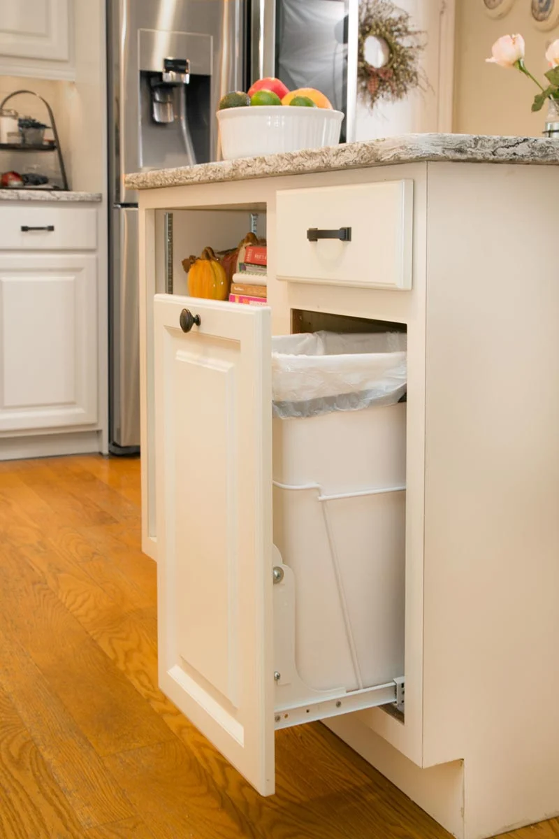 Hidden trash bins integrated into a kitchen island cabinet