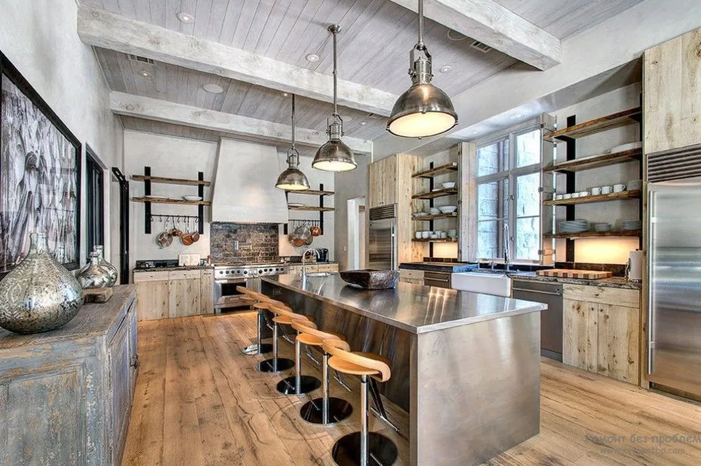 Industrial kitchen with greige elements stainless steel island wooden beams and open shelving Industrial kitchen with greige elements stainless steel island wooden beams and open shelving