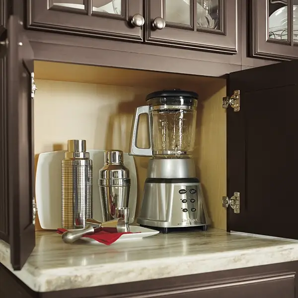 Integrated appliance garage in a small kitchen with dark cabinets