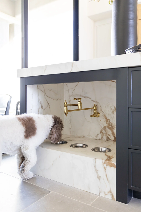 Integrated pet feeding station within a modern kitchen island Integrated pet feeding station within a modern kitchen island