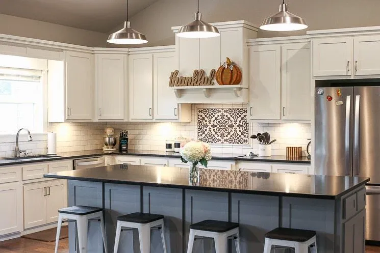 Kitchen with a two tone island white cabinets and black countertops Kitchen with a two tone island white cabinets and black countertops