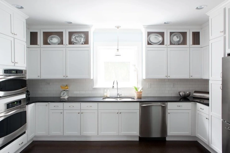 Kitchen with stainless steel appliances white cabinets and black countertops Kitchen with stainless steel appliances white cabinets and black countertops