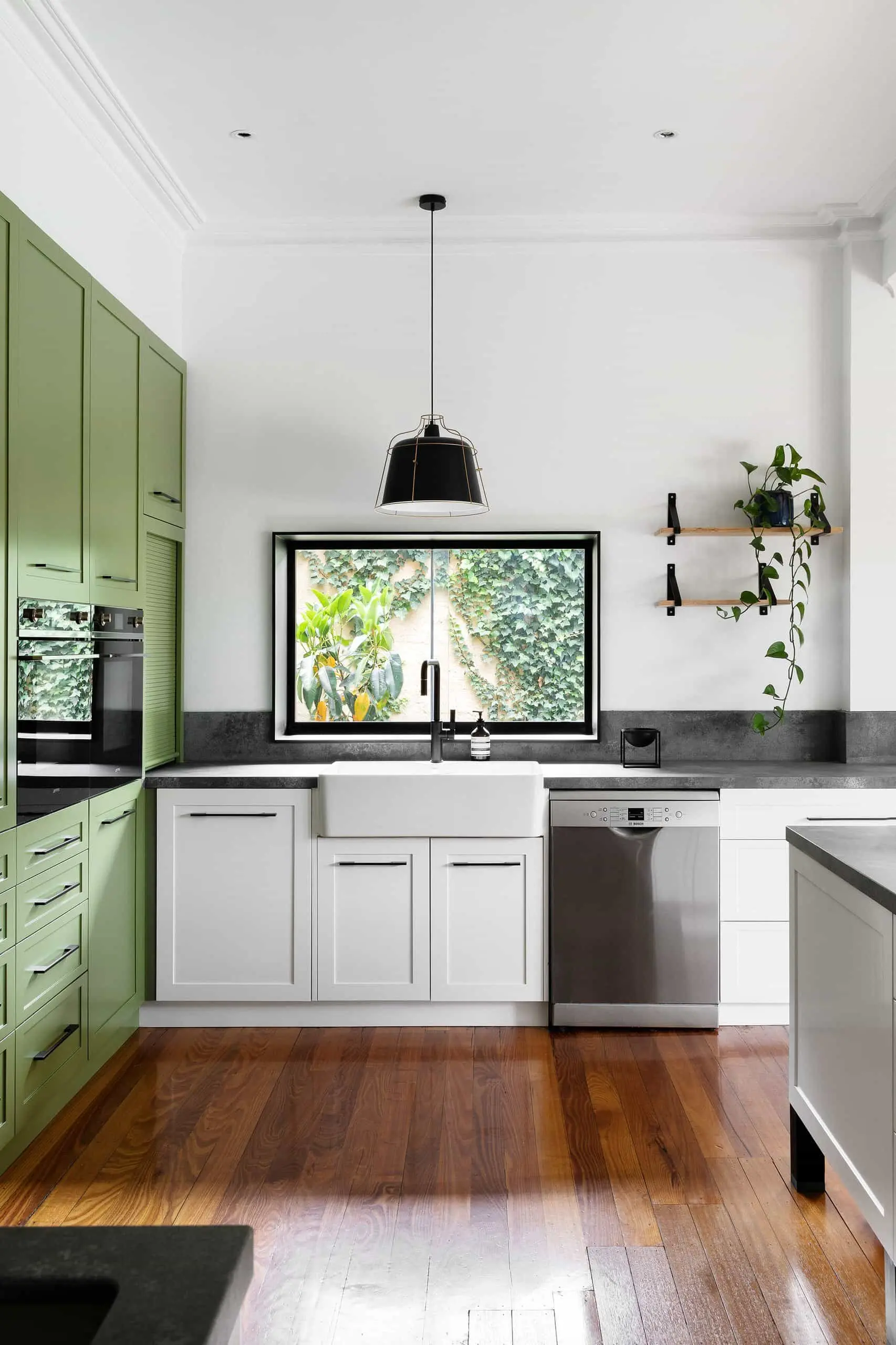 Kitchen with white cabinets black countertops and green cabinetry adding a fresh touch Kitchen with white cabinets black countertops and green cabinetry adding a fresh touch
