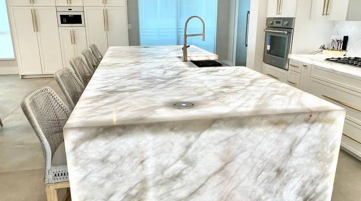 Modern kitchen island with illuminated marble countertops and integrated sink Modern kitchen island with illuminated marble countertops and integrated sink