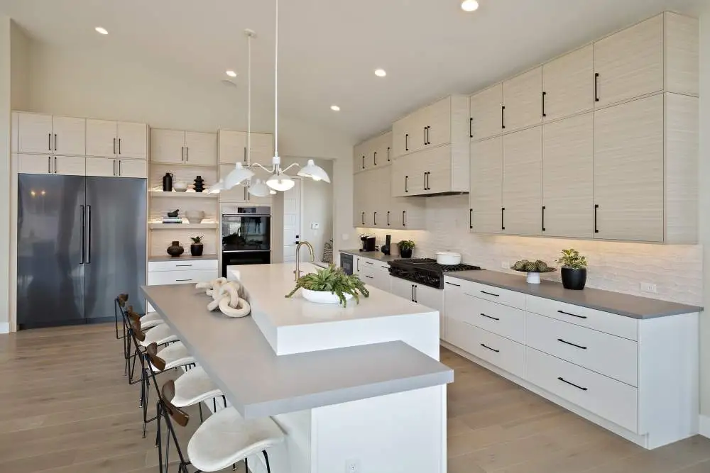 Modern kitchen with extended dining island and sleek cabinetry Modern kitchen with extended dining island and sleek cabinetry