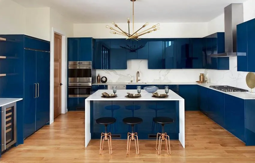 Modern kitchen with glossy blue cabinets and brass light fixture Modern kitchen with glossy blue cabinets and brass light fixture