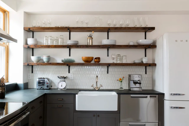 Modern kitchen with taupe cabinets and open wooden shelving featuring a farmhouse sink and various kitchenware Modern kitchen with taupe cabinets and open wooden shelving featuring a farmhouse sink and various kitchenware