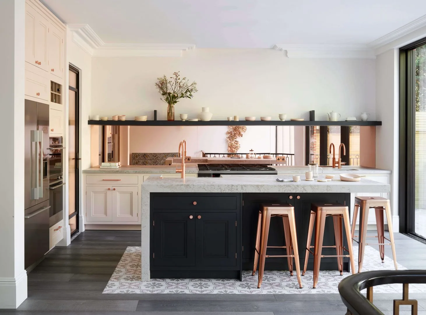 Reflective surfaces enhance light in a compact kitchen space