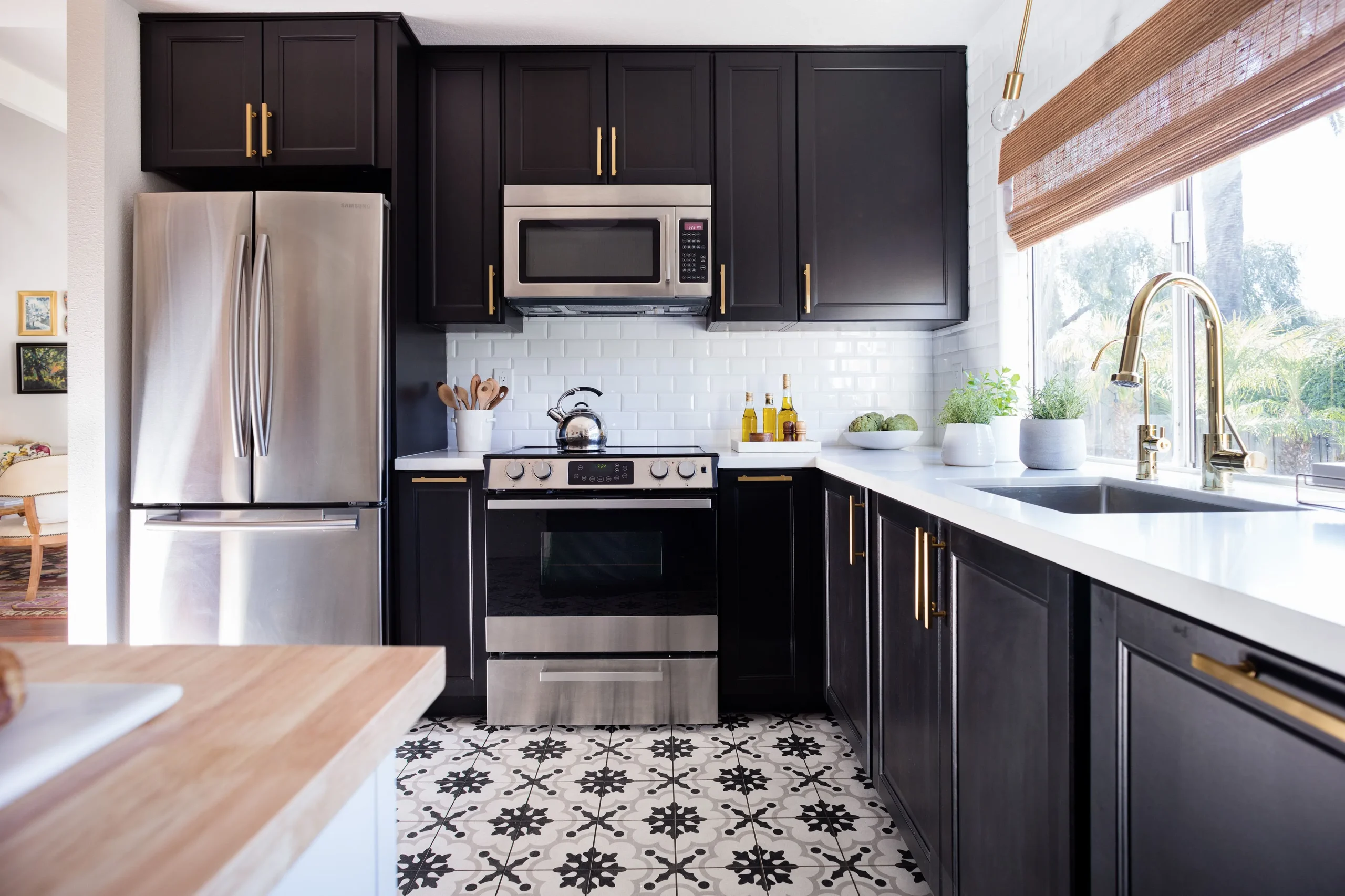 Black cabinets pair with stainless steel appliances