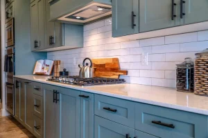 Blue kitchen cabinets with stainless steel appliances