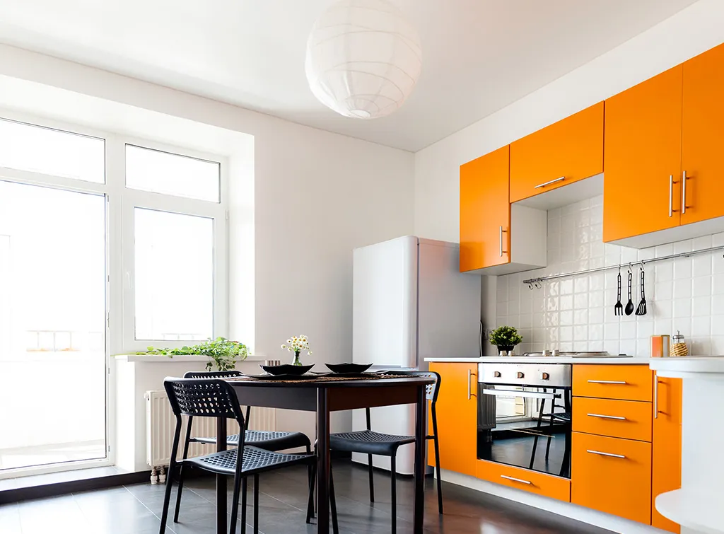 Bright Orange Cabinets Bright Orange Cabinets in a contemporary kitchen with black dining chairs