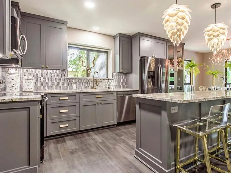 Contemporary kitchen with gray cabinets and bright decor