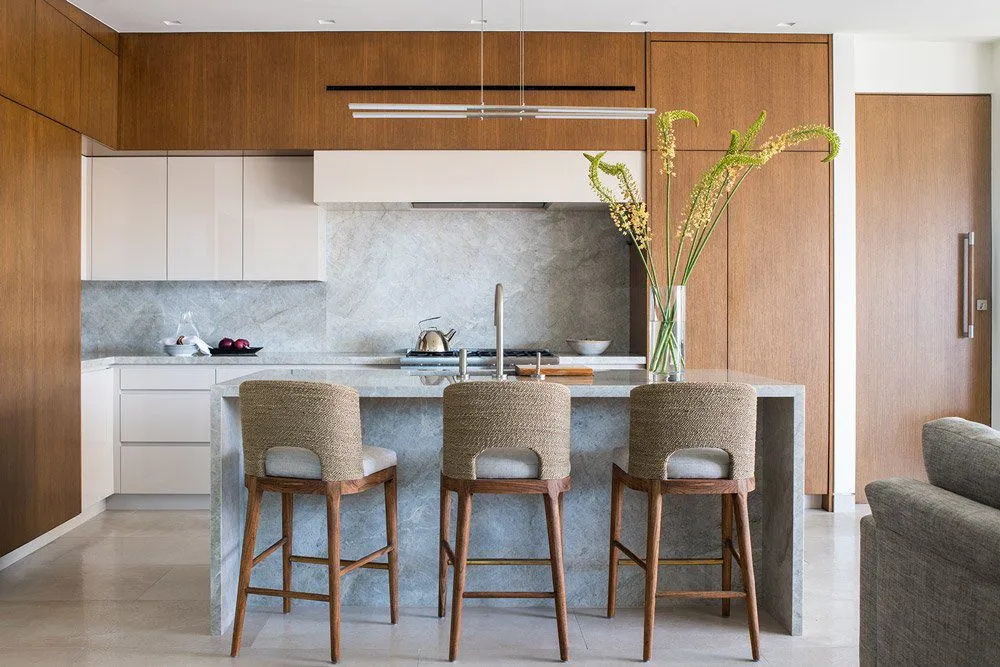 Coral base cabinets with driftwood uppers in a serene kitchen design