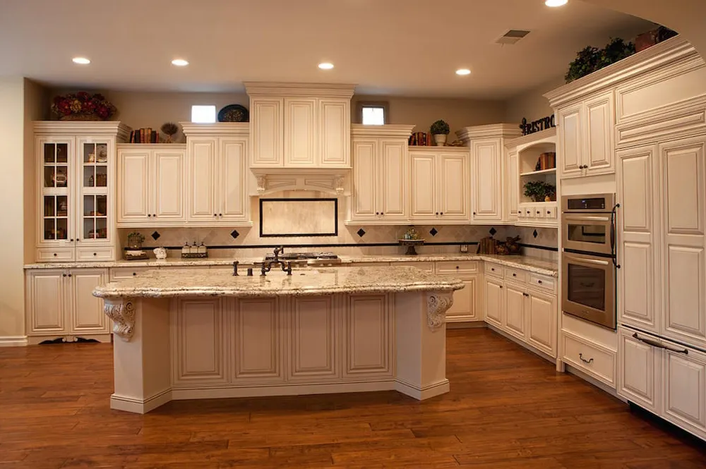 Custom white kitchen cabinets with large marble island