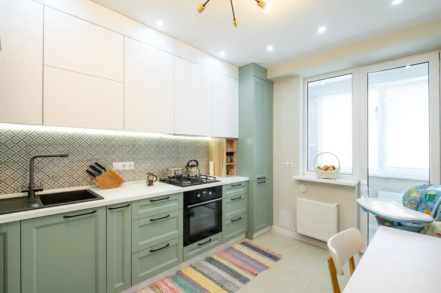 Forest Green and White two tone kitchen cabinets with a patterned backsplash