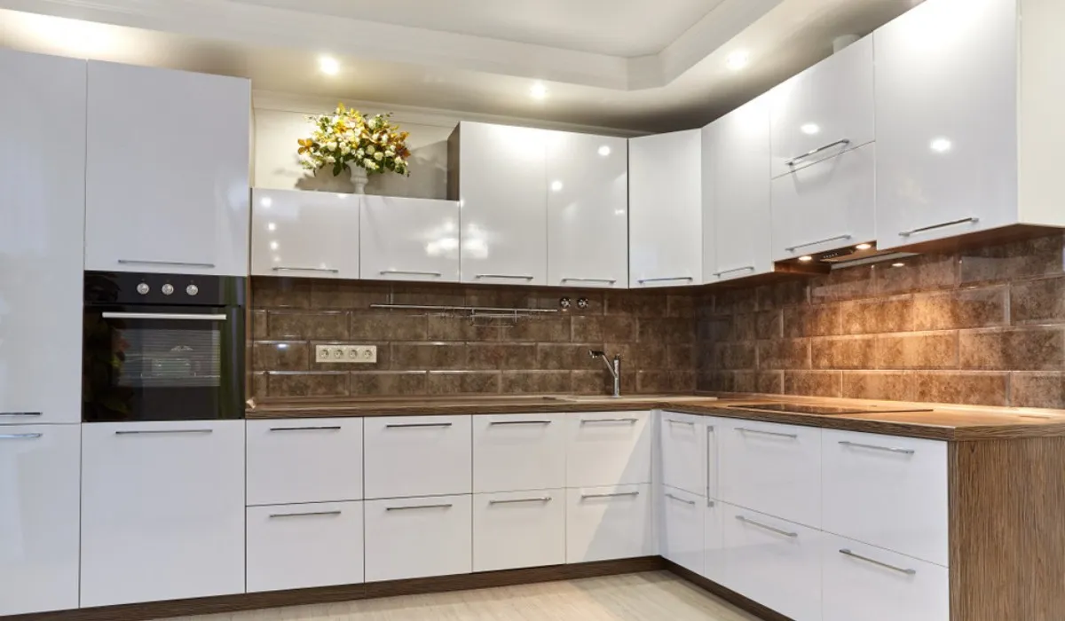 Glossy white kitchen cabinets with wood countertop finish Glossy white kitchen cabinets with wood countertop finish
