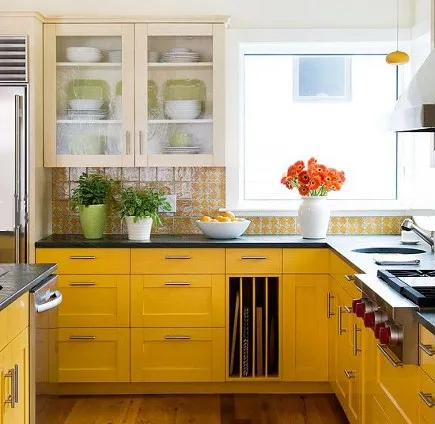Lemon yellow base cabinets with charcoal gray uppers in a bright kitchen