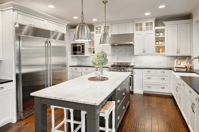 Stainless appliances in a white kitchen with a gray island