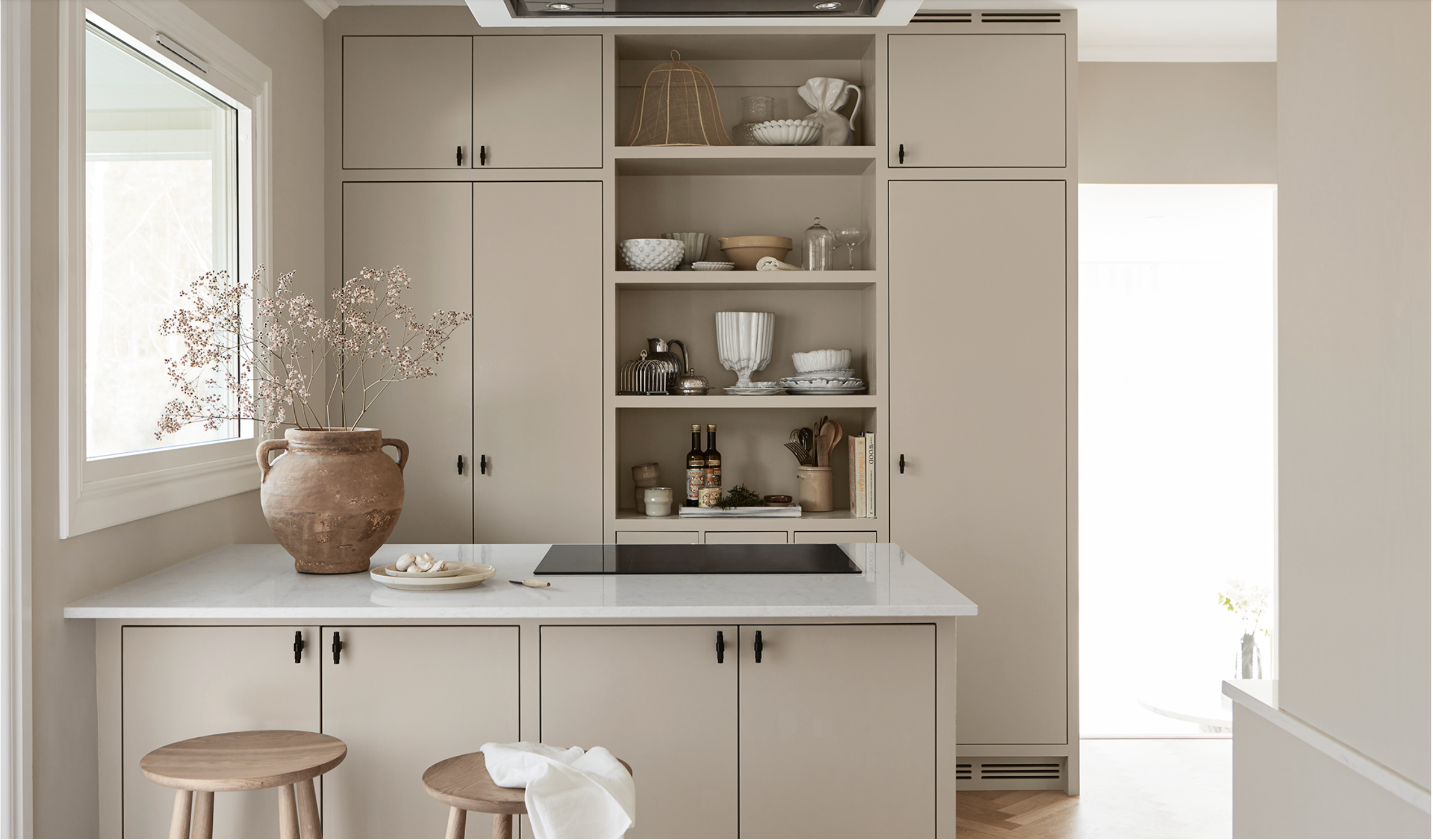 Warm Beige Cabinets Warm Beige Cabinets in a minimalist kitchen with open shelving