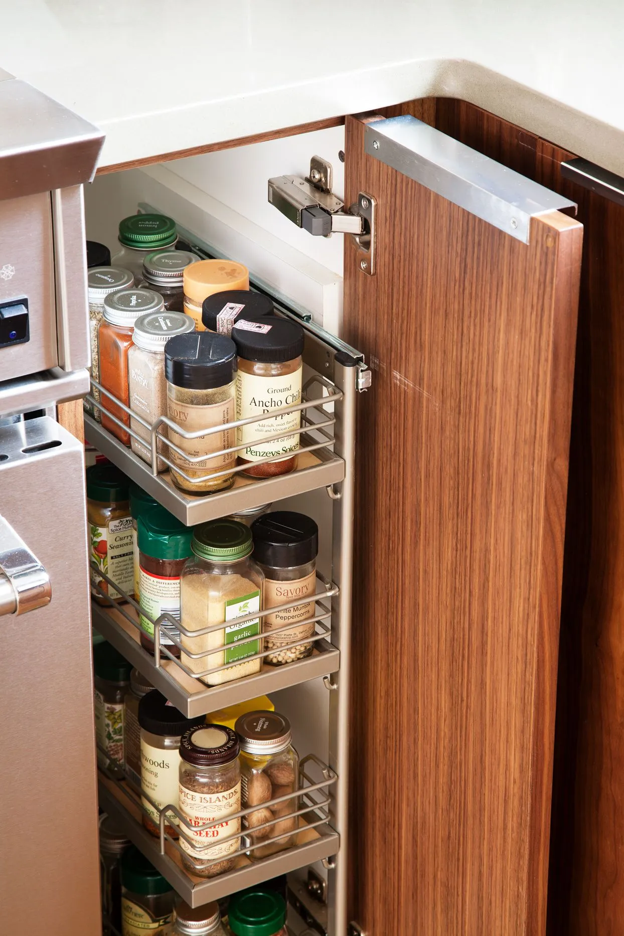 slim pull out cabinets between larger cabinets for storing spices