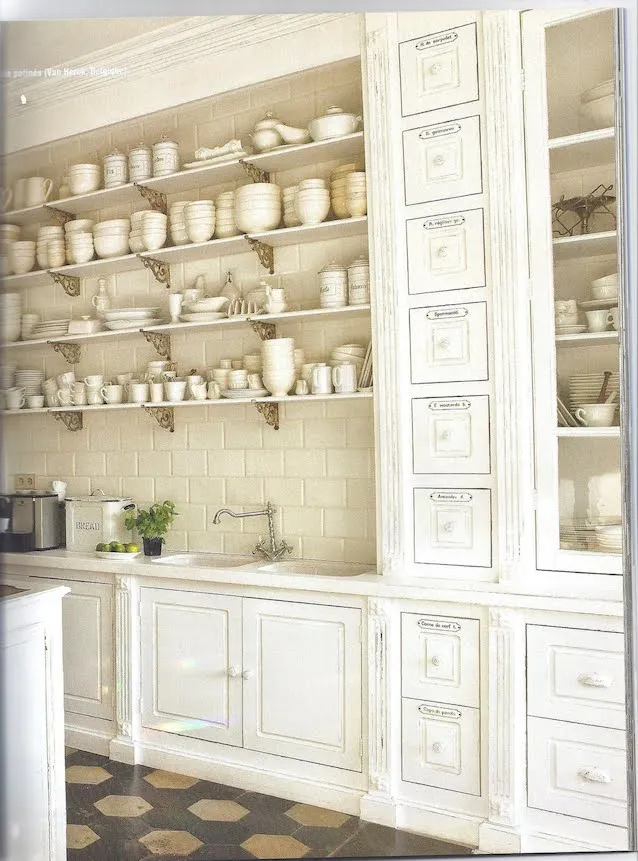 Antiqued white kitchen with open shelving and vintage drawers Antiqued white kitchen with open shelving and vintage drawers