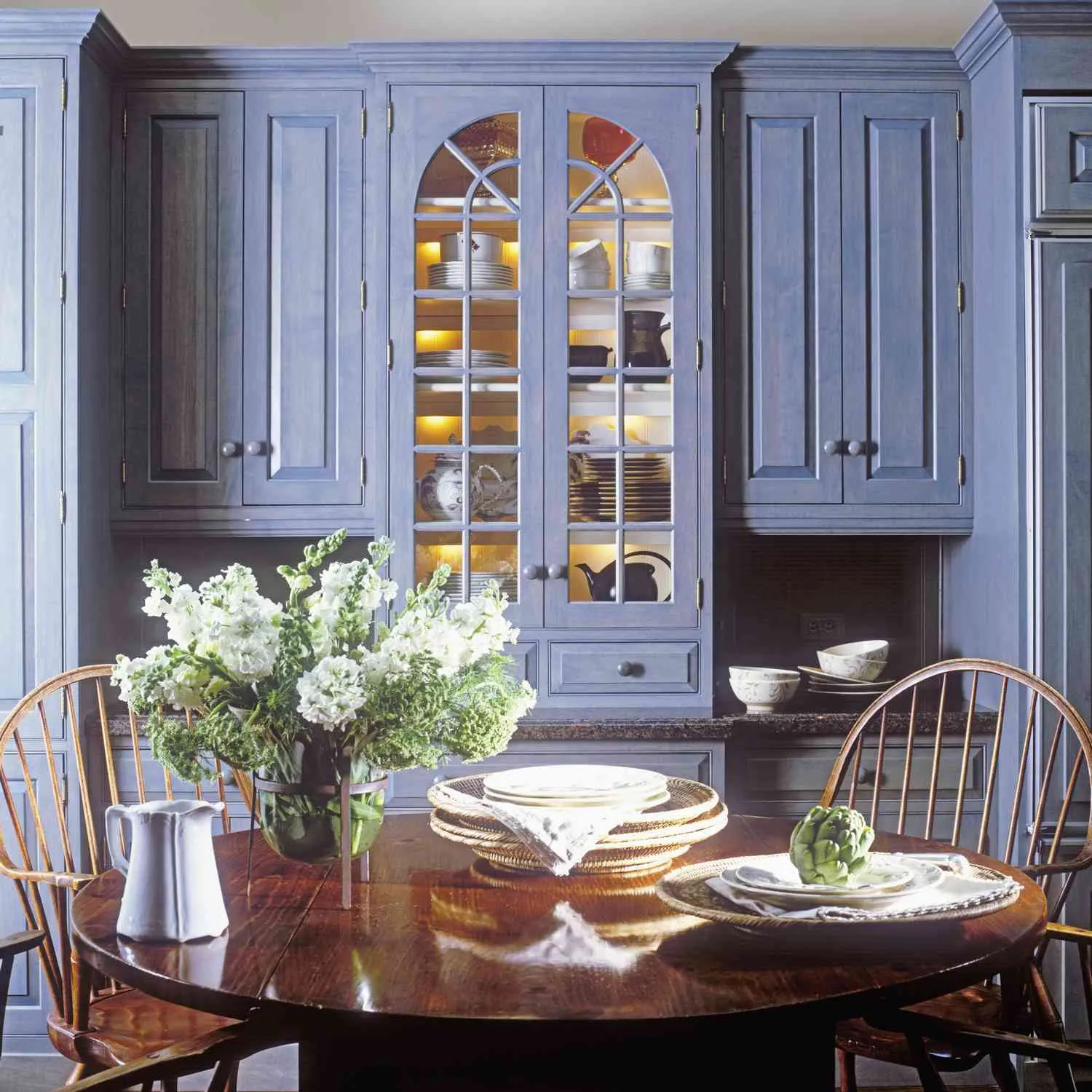 Blue wooden kitchen cabinets with glass door display Blue wooden kitchen cabinets with glass door display