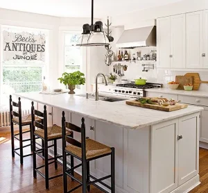 Bright white antique kitchen with a large island and vintage decor