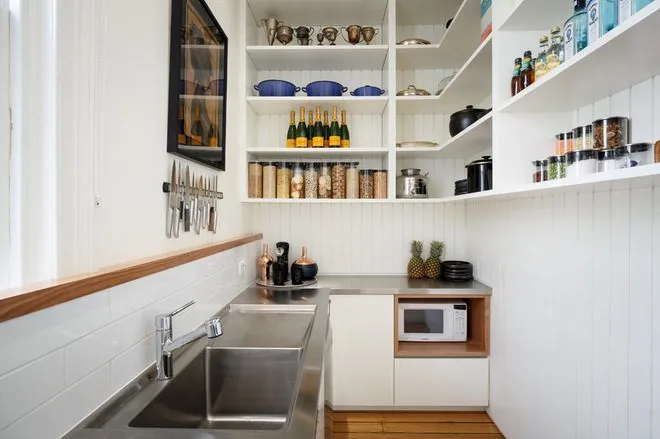 Compact kitchen with sleek open shelving and organized tools Compact kitchen with sleek open shelving and organized tools