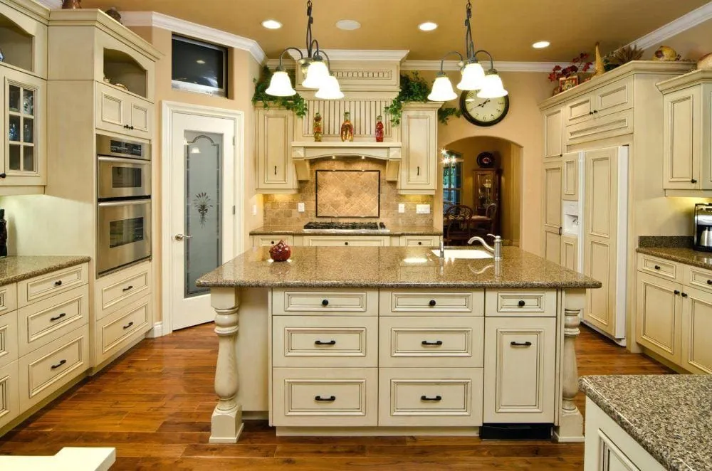 Cream colored kitchen with island and traditional cabinetry design Cream colored kitchen with island and traditional cabinetry design
